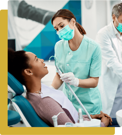 A dentist and his assistant are talking to the patient.